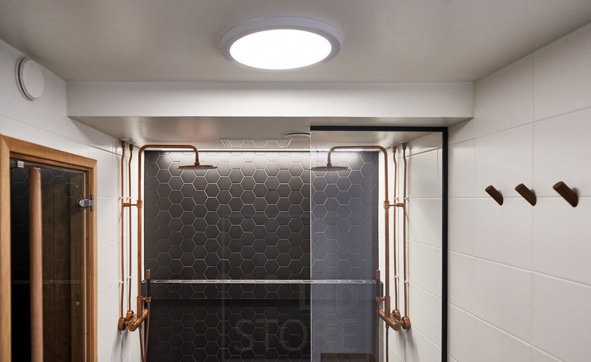 In the washroom, a led ceiling as general lighting and behind the showers, a special tile accentuated by a led strip. Ledstore.fi